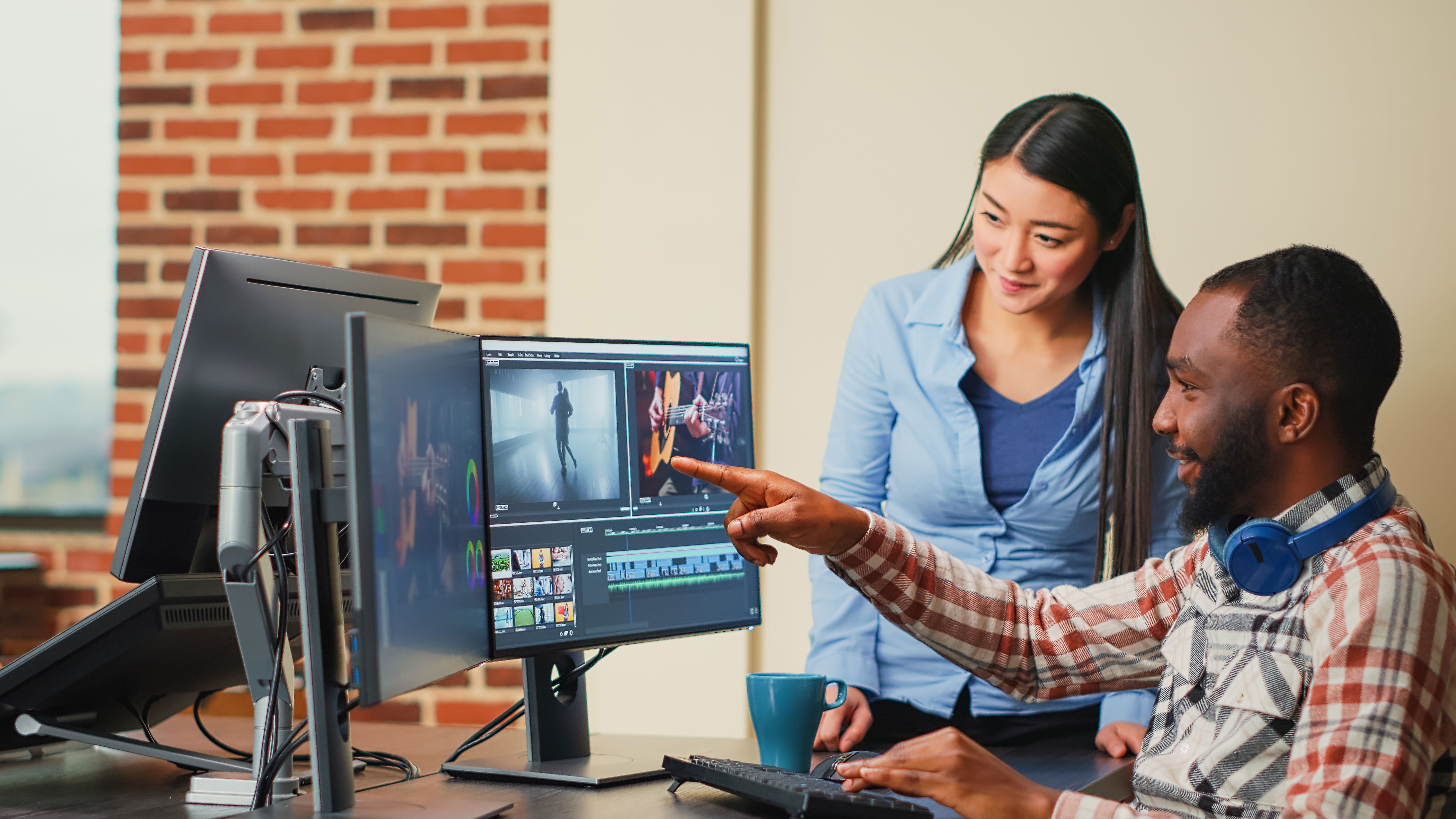 Young content creators doing teamwork working on movie footage with professional production software, creating film content. Coworkers brainstorming ideas to create video and audio montage.